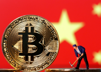 Man with pick axe mining bitcoin. A bitcoin standing in front of the Chinese flag