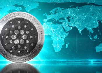 Picture of a Cardano coin in front of a map of the world