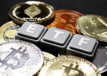Picture of ETF written with scrabble tiles with crypto coins around it