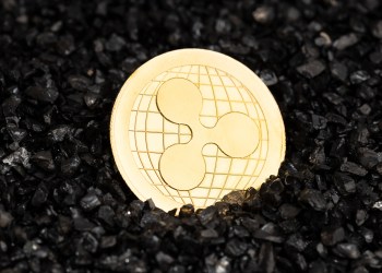 Ripple XRP coin on black gravel background